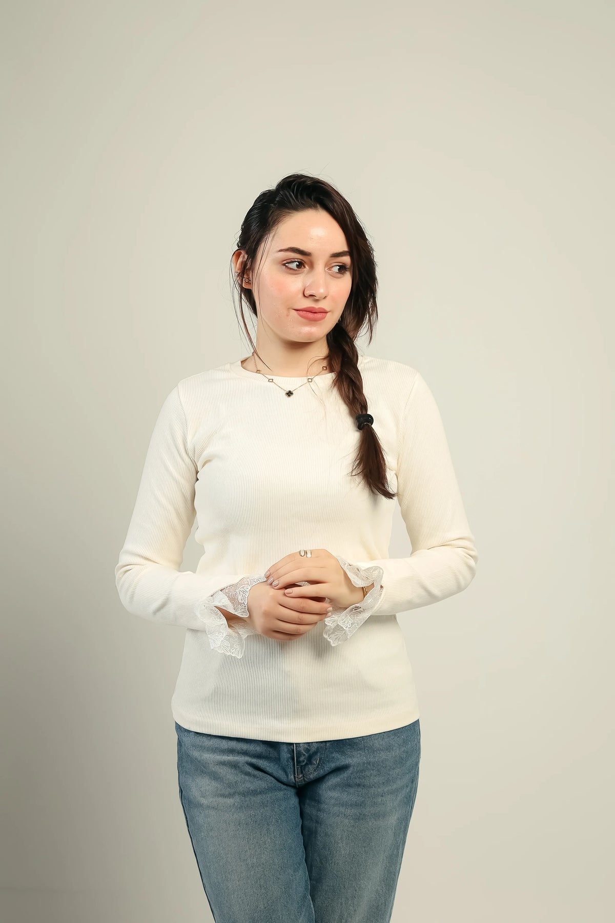 Gumus lace cuff ribbed top in offwhite, worn with jeans — front view