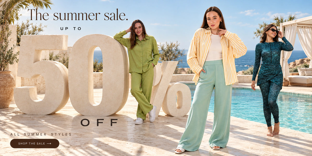 Gumus summer sale — women in summer styles beside a pool with a giant 50% OFF sculpture