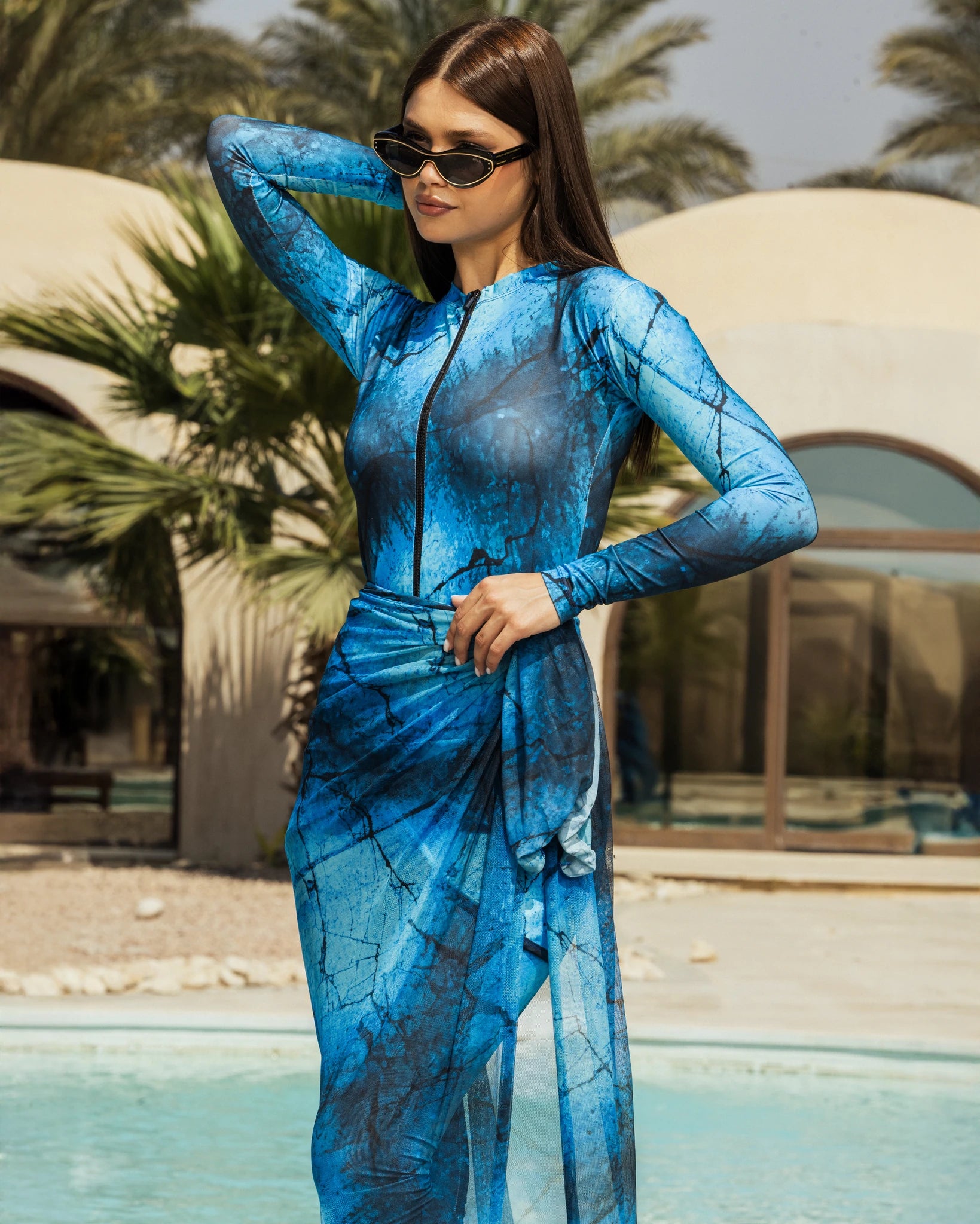 Woman in blue snakeskin print modest swimsuit burkini with sarong