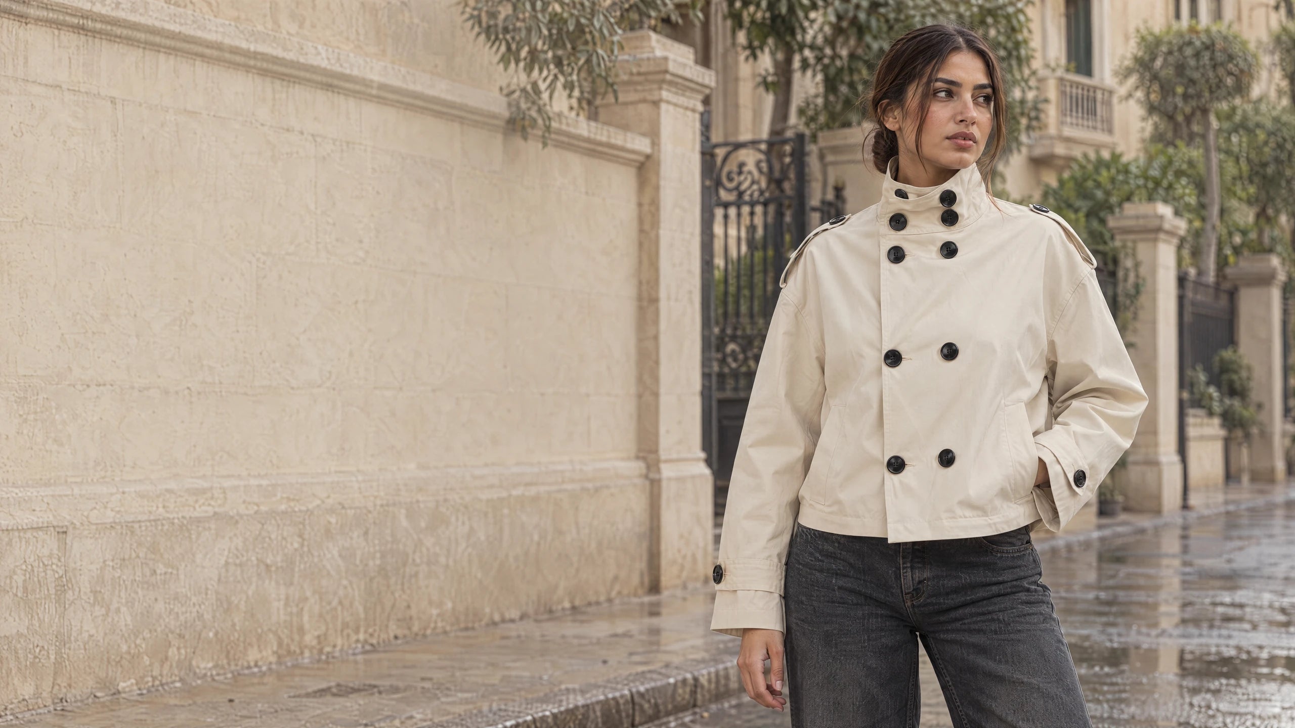 Model wearing the GUMUS cream cropped military trench in a Cairo winter setting